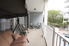 Lower Balcony with three person swing, table, four chairs
