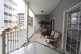 Lower Balcony with three person swing, table, four chairs